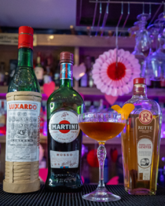 The Bridal Suite cocktail on a home bar top, surrounded by its ingredients