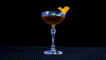 The Bridal Suite cocktail on a home bar top with an all black background