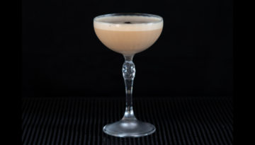 The Cappuccino Martini on a home bar top with an all black background