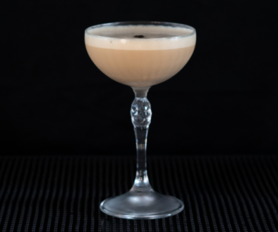 The Cappuccino Martini on a home bar top with an all black background