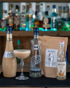 The Cappuccino Martini on a home bar top surrounded by its ingredients