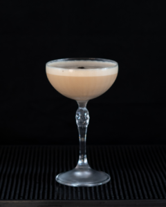 The Cappuccino Martini on a home bar top with an all black background