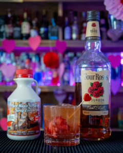 The Kentucky Kiss on a home bar top surrounded by its ingredients 
