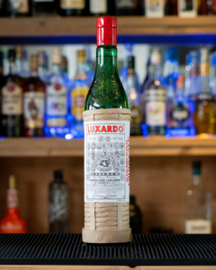 A bottle of Luxardo Maraschino Liqueur on a home bartop