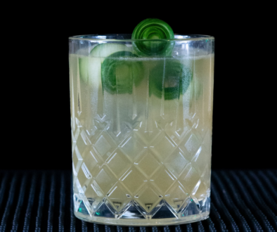 The Irish Maid cocktail on a home bar top with an all black background