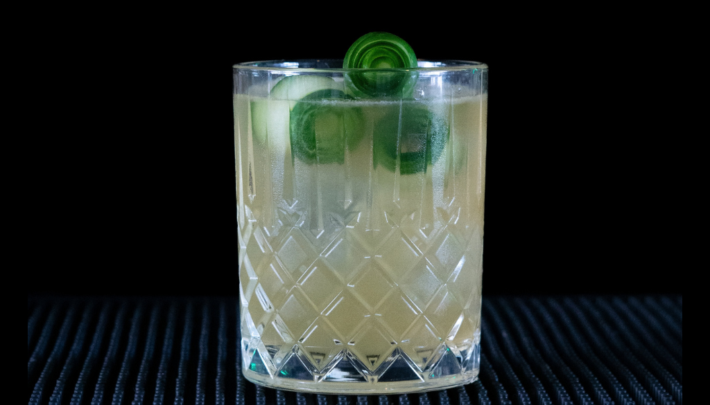 The Irish Maid cocktail on a home bar top with an all black background