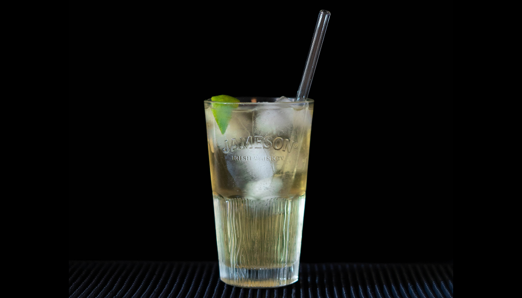 The Jameson Ginger & Lime (JGL) cocktail on a bartop, with a black background