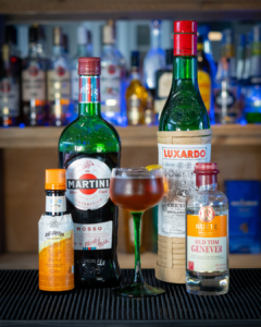 The Martinez on a home bar top surrounded by its ingredients