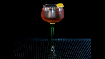 The Martinez on a home bar top with an all black background