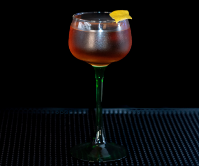 The Martinez on a home bar top with an all black background