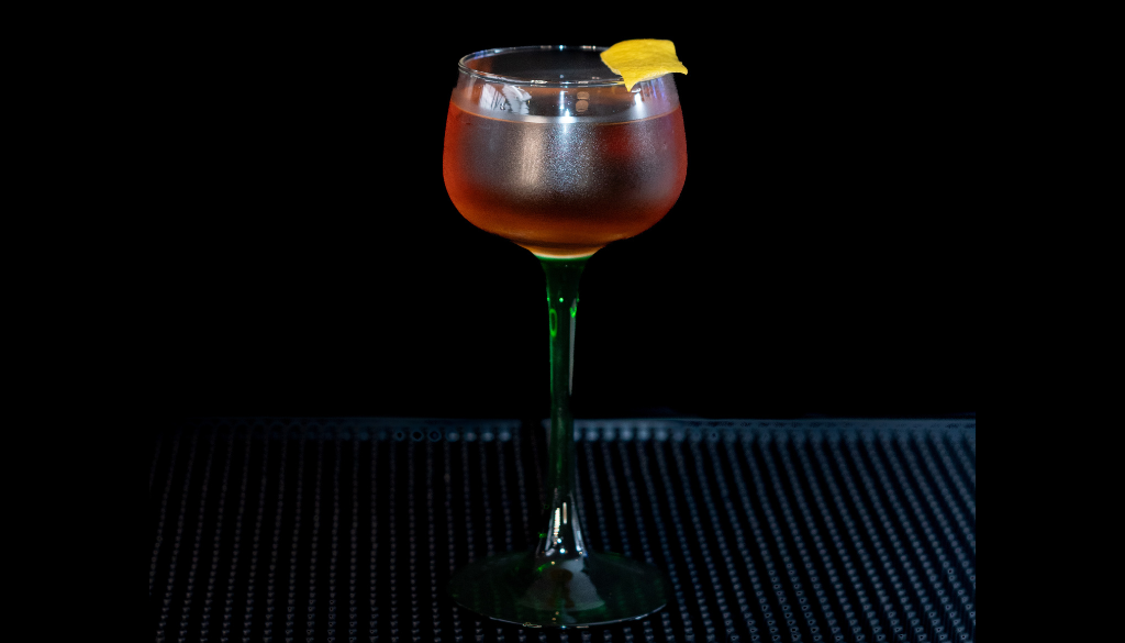 The Martinez on a home bar top with an all black background