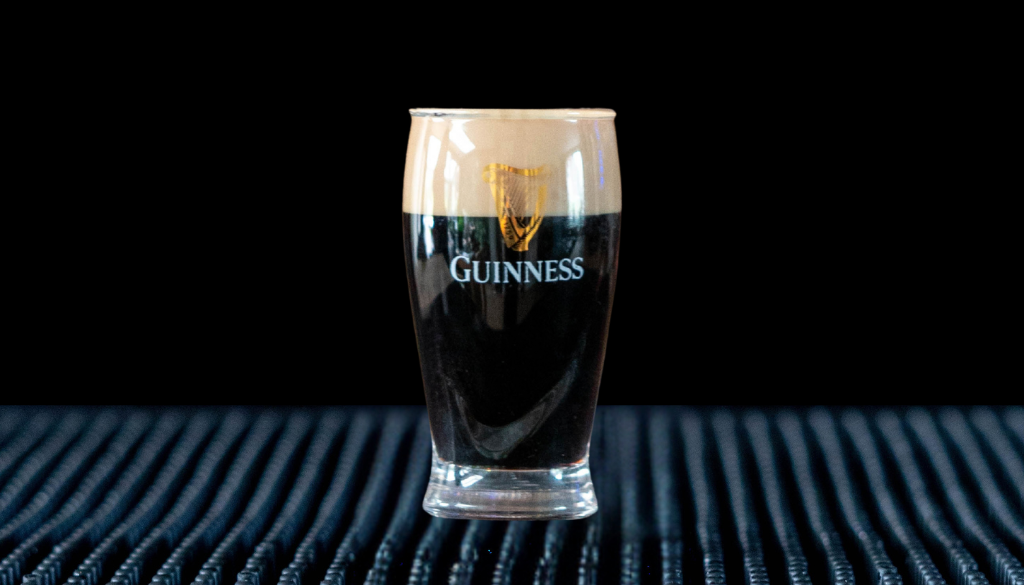 The Baby Guinness Shot on a home bar top with an all black background