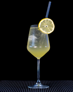 The Limoncello Spritz cocktail on a home bar top with an all black background