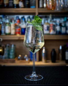 The Lychee Spritz cocktail on a home bar top
