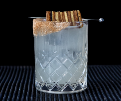 The Spekkoek Margarita cocktail on a homebar top, with an all black background