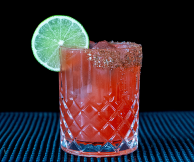 The Watermelon Margarita cocktail on a homebar top, with an all black background