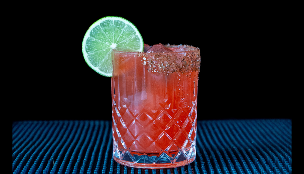The Watermelon Margarita cocktail on a homebar top, with an all black background
