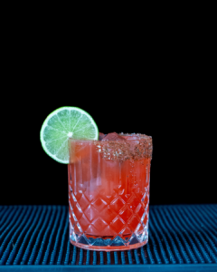 The Watermelon Margarita cocktail on a homebar top, with an all black background