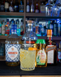 The Mallorcan Margarita on a home bar top, surrounded by its ingredients