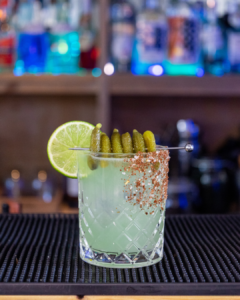 The Pickle Margarita cocktail on a home bar top